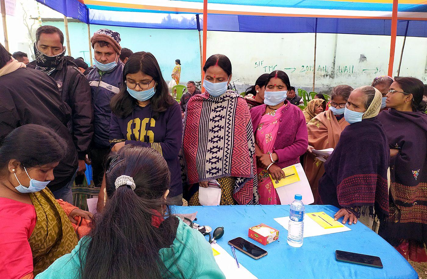Patients waiting in line at a Wellity Care community health camp